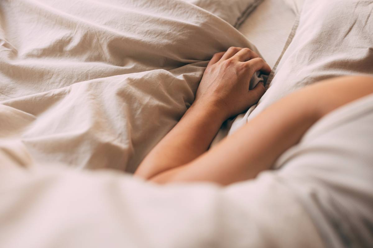 Image of person under covers in bed