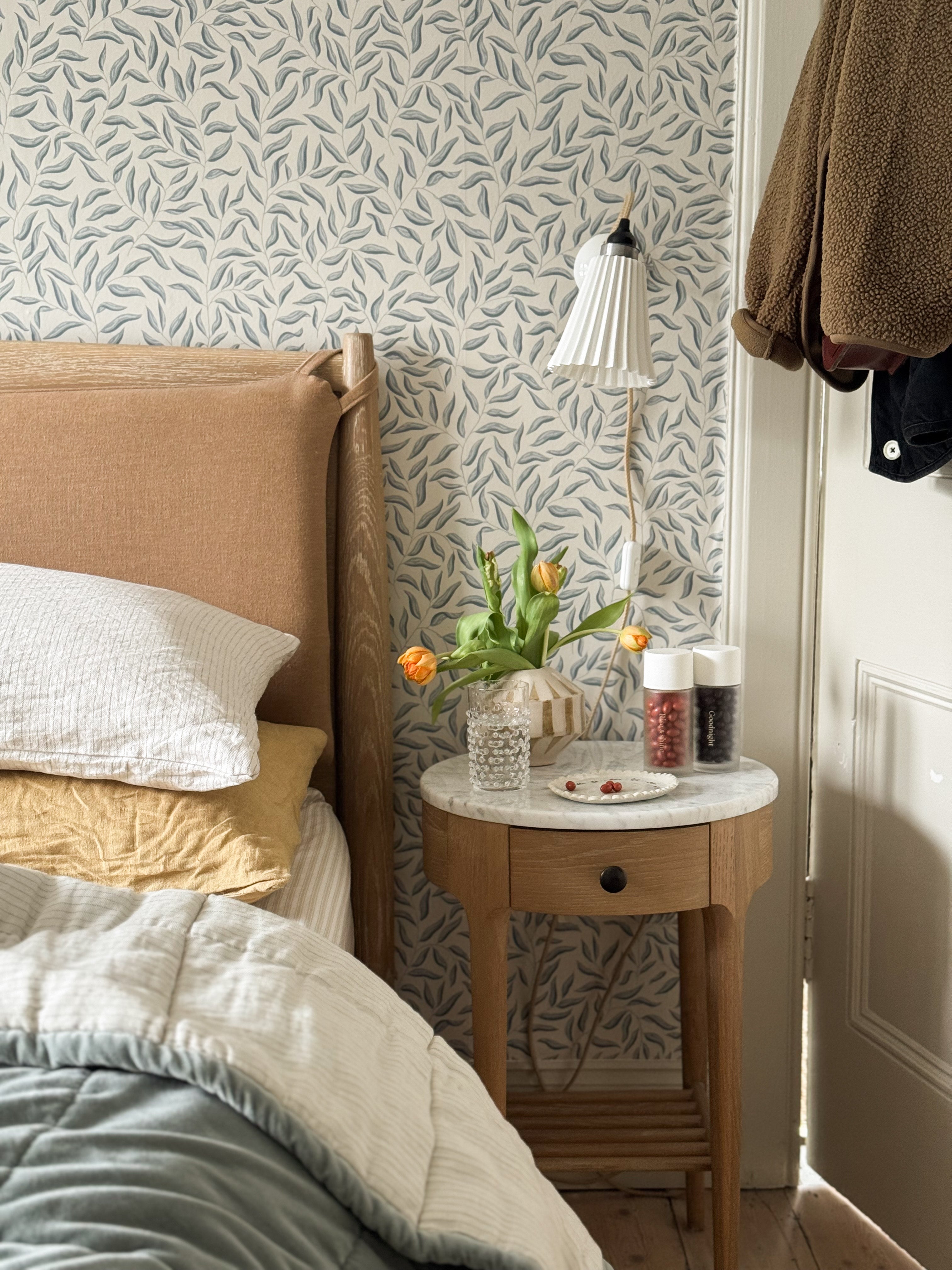 Bedroom with Morning & Night bottles on bedside table