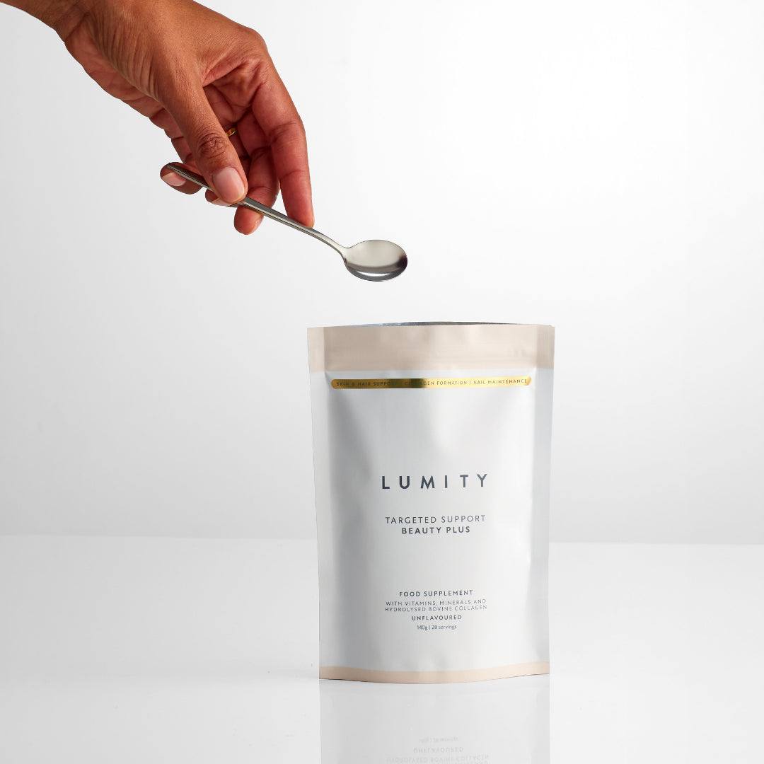Lumity supplement package with a hand holding a spoon over it