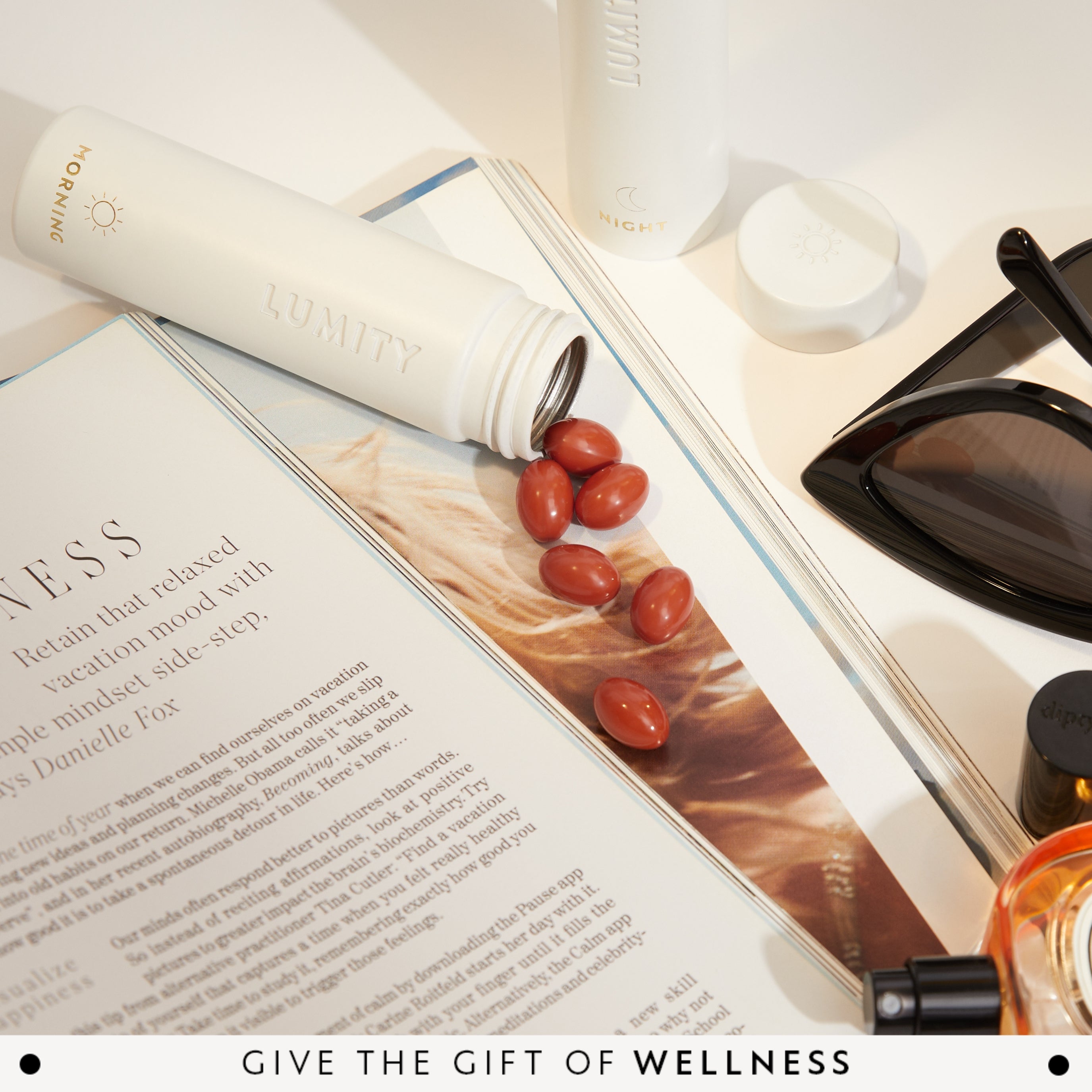 Vitamins spilling from a Travel Case onto an open magazine with a focus on wellness.