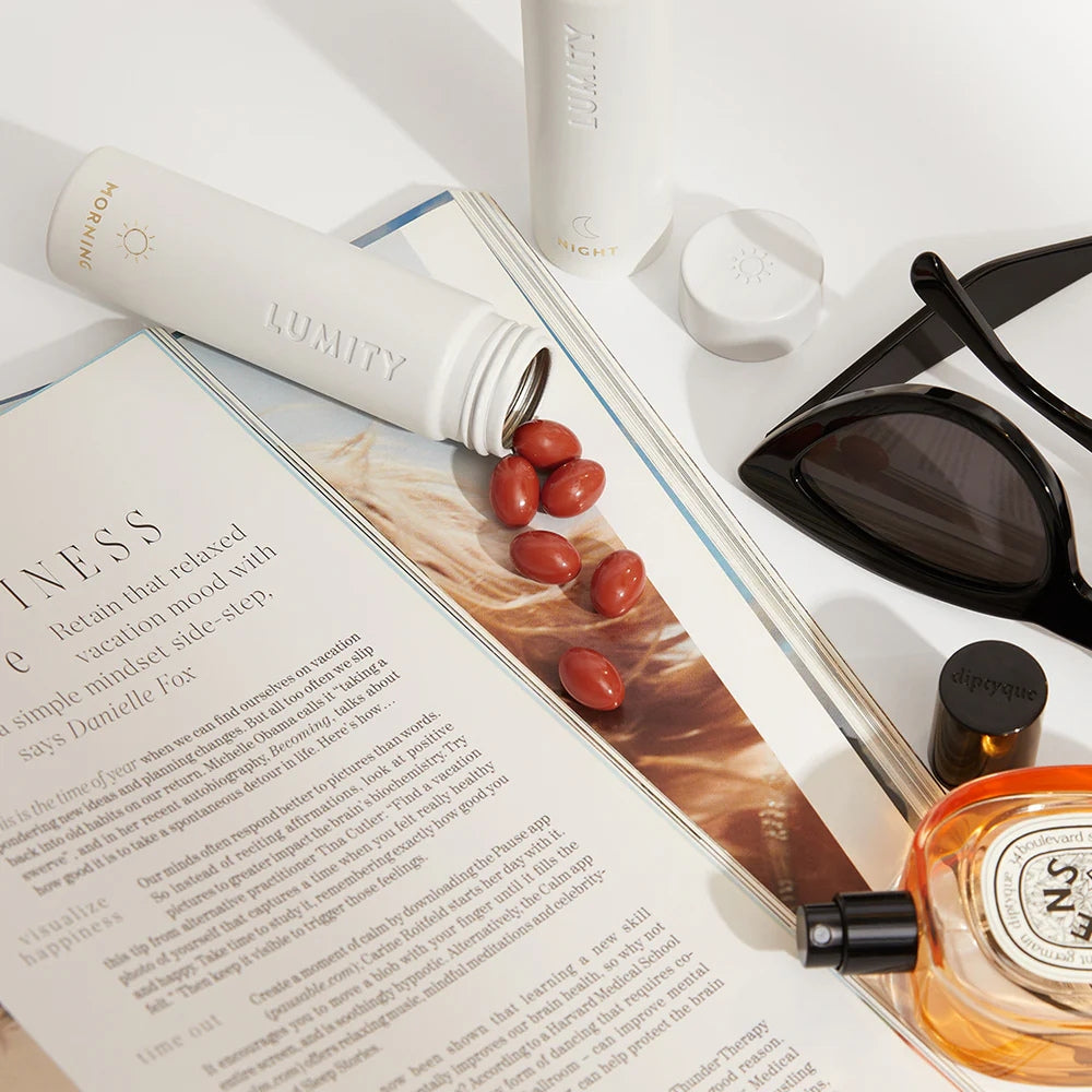 Vitamins spilling from a Travel Case onto an open magazine with a focus on wellness.