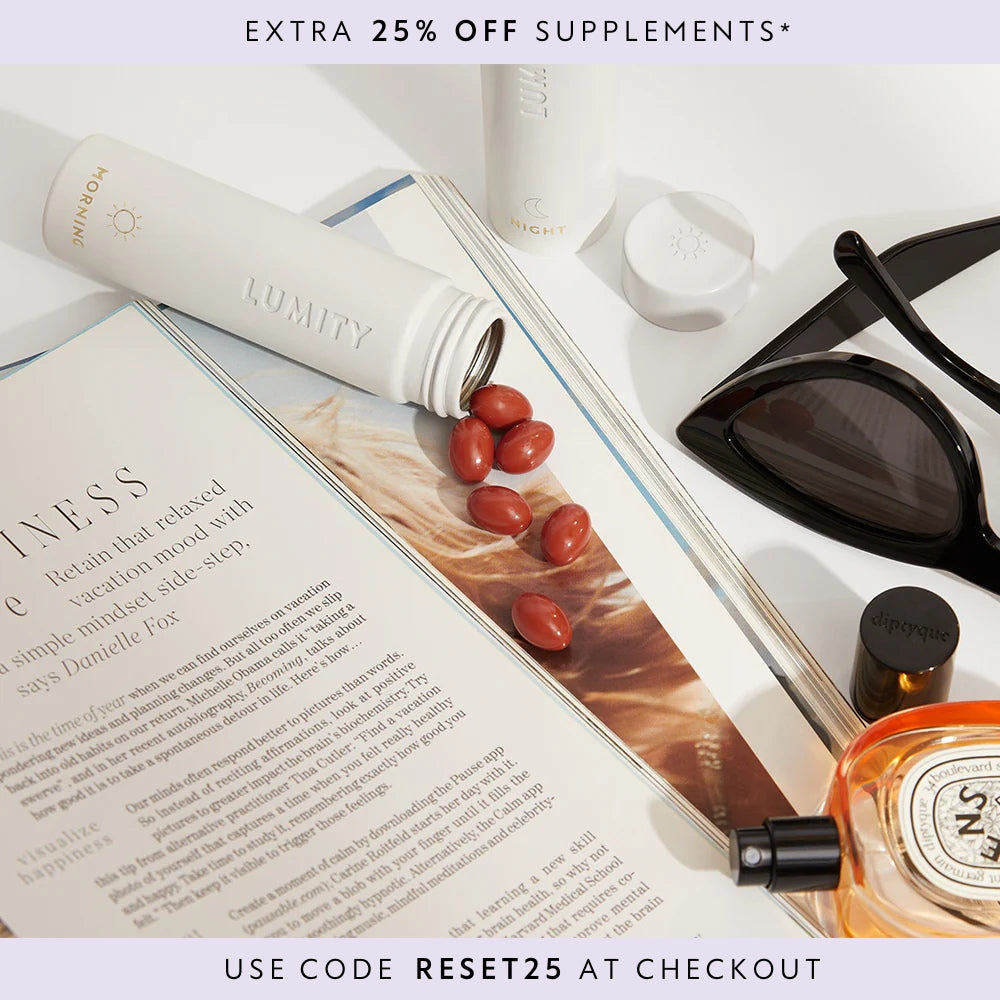 Travel Cases laying on a table necx to a pair of sunglasses, magazine and perfume with supplements coming out