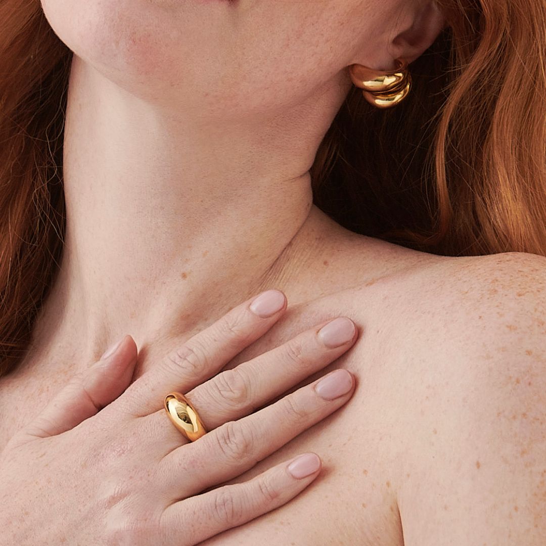 Close-up of a woman with her hand on her collar bone