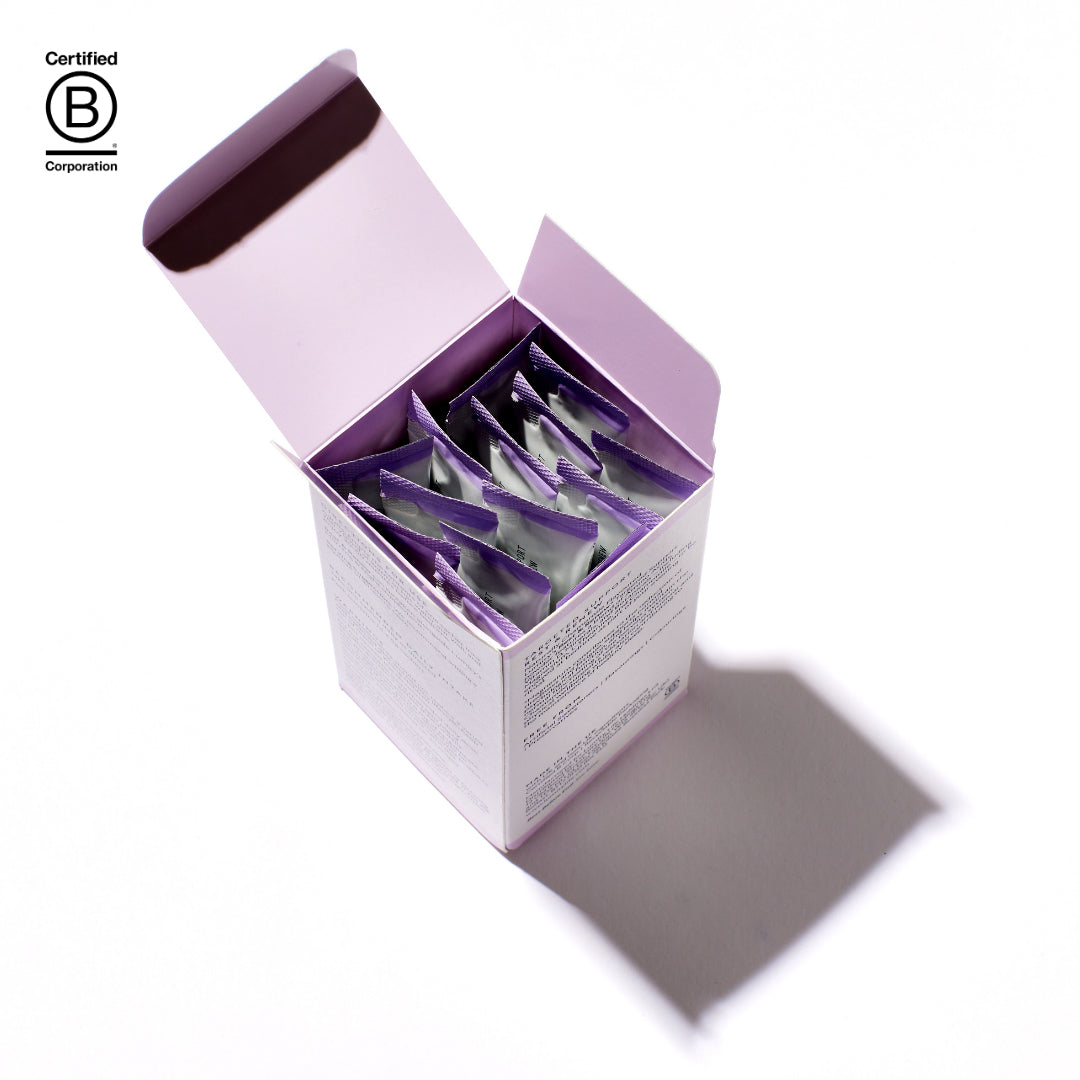 Open purple box containing small packets on a white background, with 'Certified B Corporation' logo.