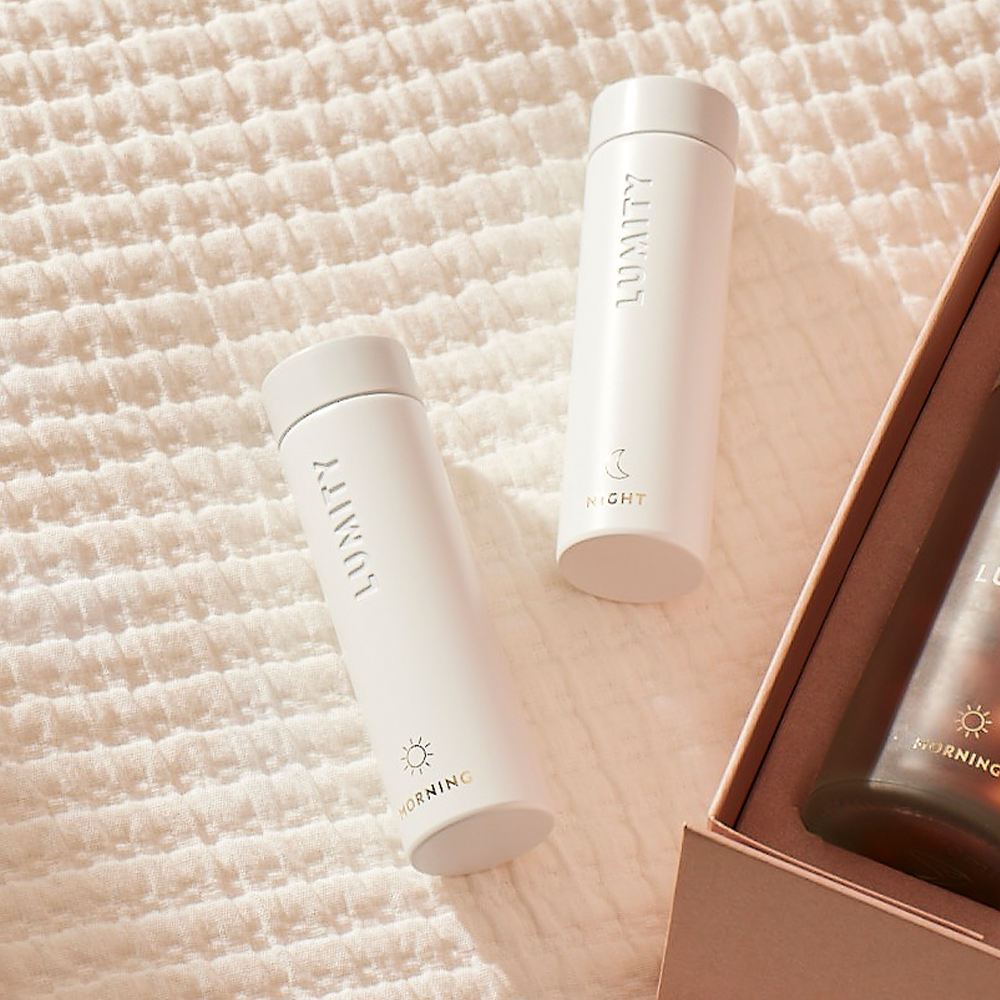 Morning & Night Supplement Travel Cases on a light background, in the corner Lumity Morning Bottle inside a Lumit Morning & Night starter kit