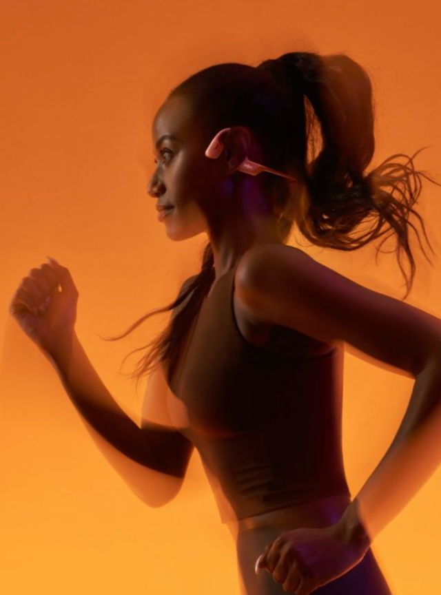 Woman running on orange background