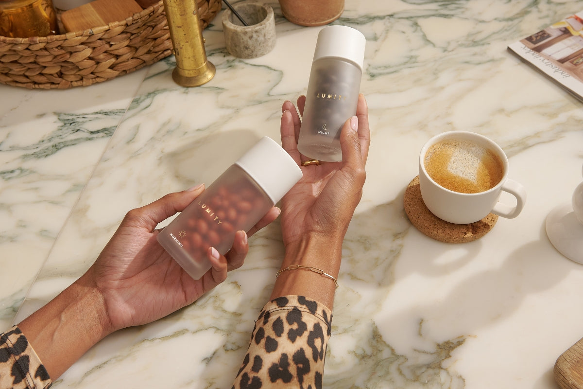 Woman holding Morning & Night supplement bottles