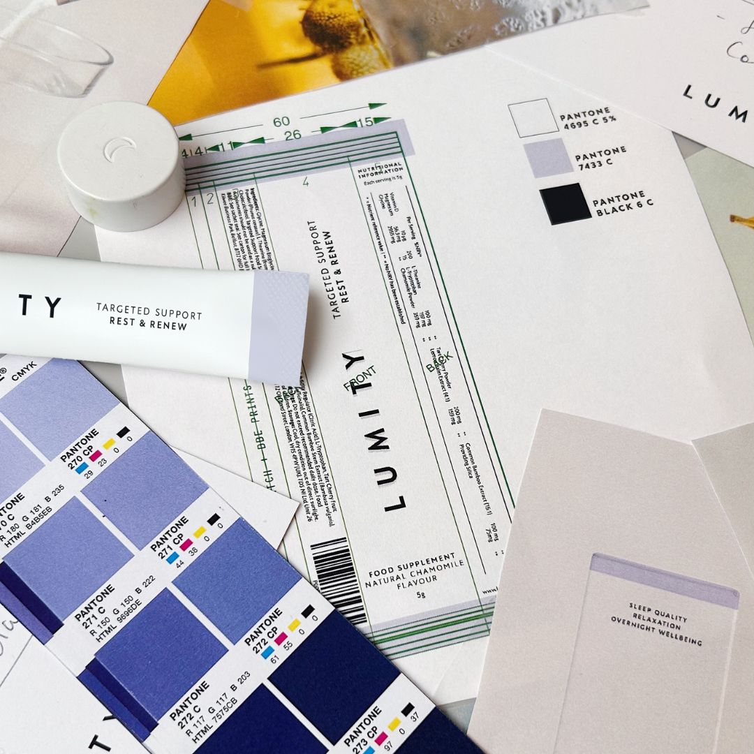 Flat lay of Lumity supplement design sketches, color swatches, and packaging mockups for targeted support and rest products