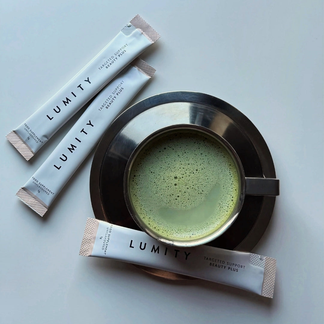 Lumity BeautyPlus collagen powder sachets with a cup of matcha on a light background
