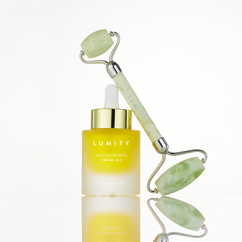Lumity Skin Nutrients Facial Oil and Jade Facial Roller on a white background