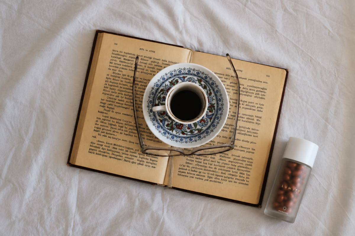 Morning bottle next to book, reading glasses and tea