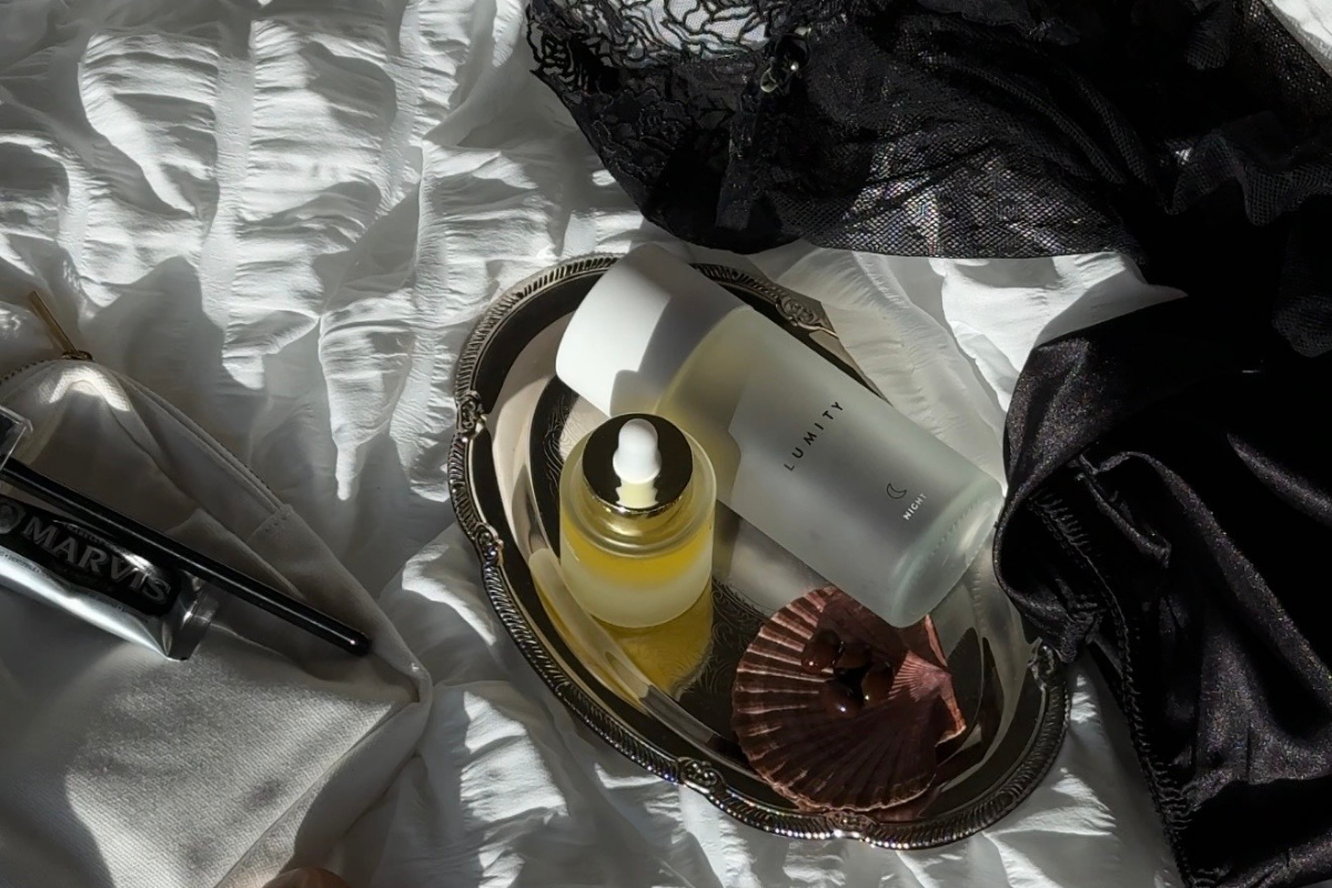 Image of Morning & Night supplement bottle with seashell and lingerie on bed